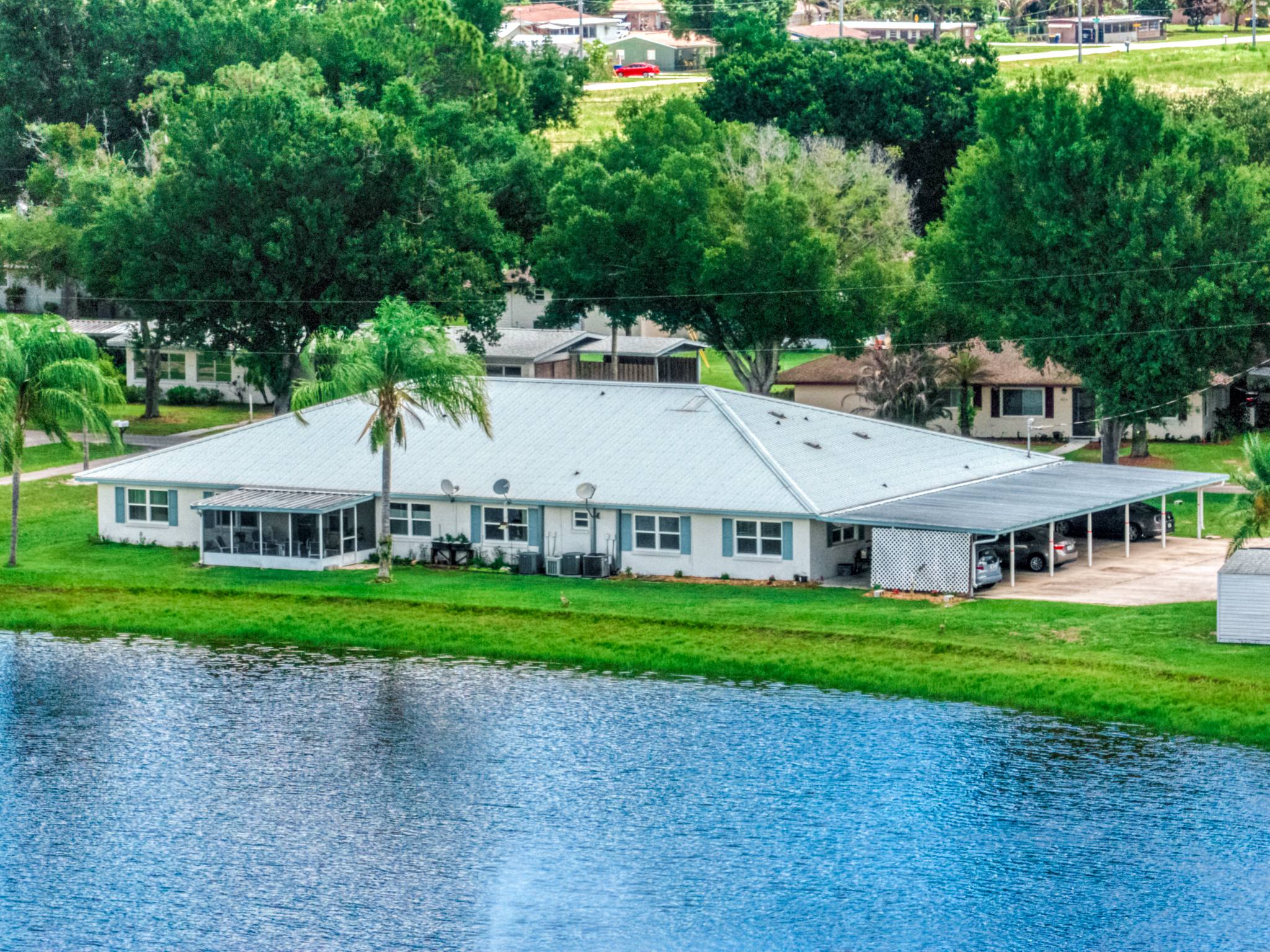 The Lodge seen from above the lake, with its carports